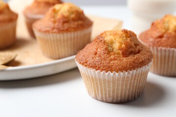 Delicious sweet muffins on white table, closeup. Space for text