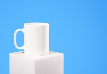 White ceramic drinking cup. Deluxe tableware. Copy space for text.