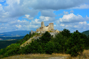 ruiny zamku na górze, castle, ruins of a castle on a hill against the blue sky	 - obrazy, fototapety, plakaty