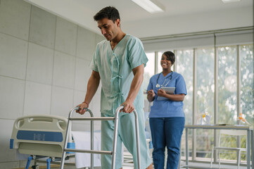 Professional physiotherapist examining and care body to young man in rehabilitation physical center. African female doctor treating muscle and joint injuries to male in hospital. Orthopedic concept.