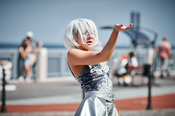 Young sexy girl in space silver micro skirt dancing with smooth, feminine and graceful movements,...