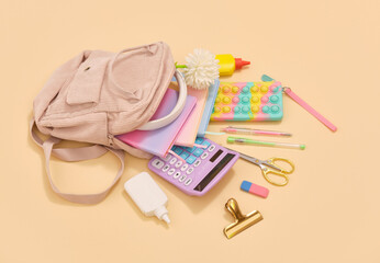 School and backpack. Variety of school supplies. Creative workspace.