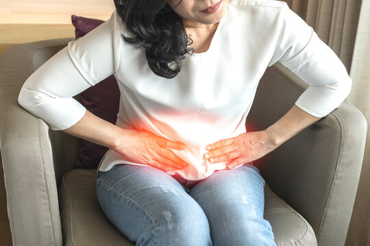 Abdominal pain in woman with stomachache illness from menstruation cramps, stomach cancer, irritable bowel syndrome, pelvic discomfort, Indigestion, Diarrhea or GERD (gastro-esophageal reflux disease)