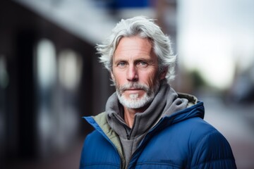 Portrait of a senior man with grey hair on the street.