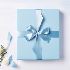 Blank blue piece of paper with gift silk ribbon bow