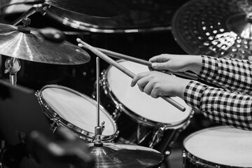 Hands of a girl playing a drum kit in black and white - 740087633