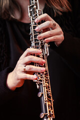 Hands of a woman playing the oboe