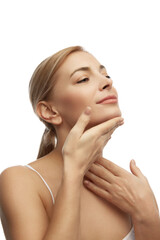 Obraz na płótnie Canvas Portrait of young woman with soft and smooth skin, doing neck massage against white studio background. Anti-aging procedures. Concept of natural beauty, spa treatments, cosmetology, female health. Ad