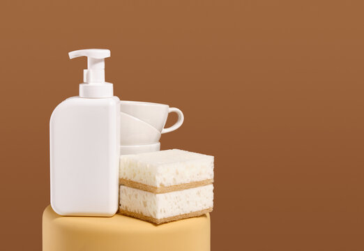 Kitchen dish work. White gel dispenser and sponges for dishwashing. Copy space for text.