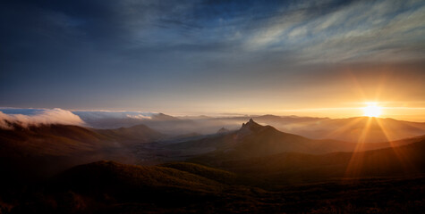 The Colorful sunset over the mountain hills