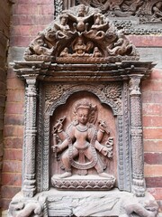 The statue depicts a hindu god in a proud stance at darbar square,patan,nepal