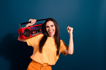 Portrait of champion in dj battle young woman fist up likes loud music holding tape recorder...