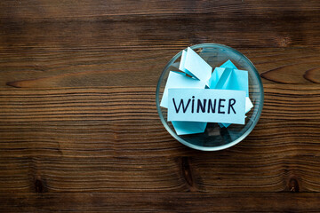 Winner concept. Lottery winner ticket in glass bowl full of paper sheets