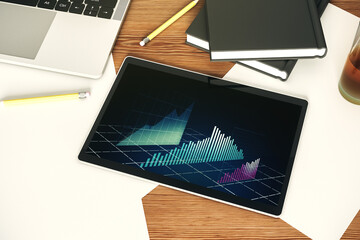 Modern digital tablet monitor with abstract creative financial chart, research and analytics concept. Top view. 3D Rendering