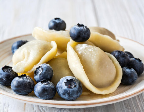 Vareniki with berry filling, blueberry dumplings isolated on white background