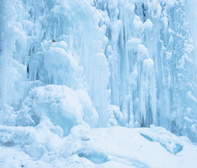 Fototapeta na wymiar Texture of a frozen waterfall in winter. Ice texture.