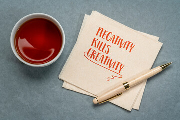 negativity kills creativity, note on a napkin, negative mindset or environment can inhibit creative...