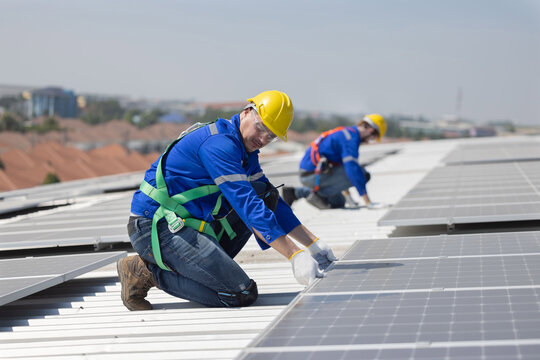 Engineer checking on solar panel on the factory rooftop