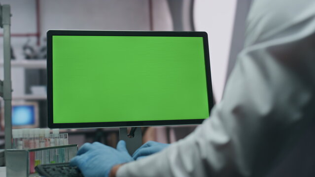Gloves hands typing keyboard green screen computer in laboratory close up. - Powered by Adobe