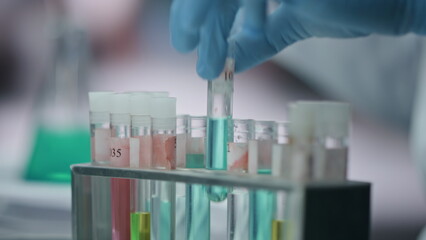 Doctor hands taking sample vaccine in test tube working laboratory close up.