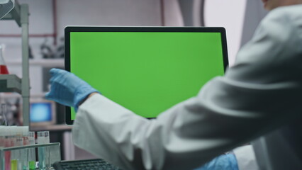 Unrecognizable scientist working mockup computer in modern laboratory closeup
