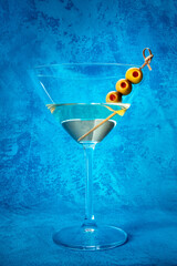 Martini. A glass of dirty martini cocktail with vermouth and olives