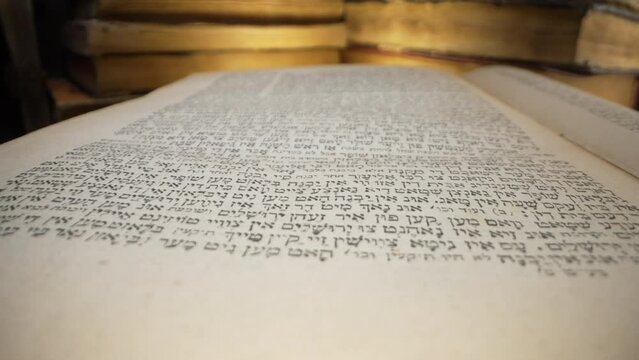 Journey through sacred Ketuvim scriptures. Revered texts in macro footage. Old yellowed jewish antique book.