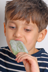 Little kid eating green popsicle - 740125252