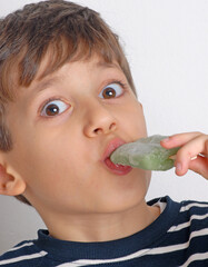 Little kid eating green ice popsicle - 740125269