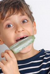Little kid eating green ice popsicle - 740125292