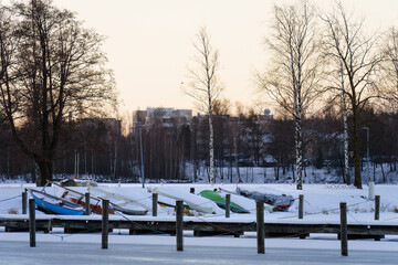 Frozen harbor in winter with snow covered boats