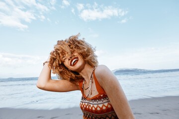 Smiling Woman with Backpack on Beach, Enjoying Happy Vacation in Nature's Freedom