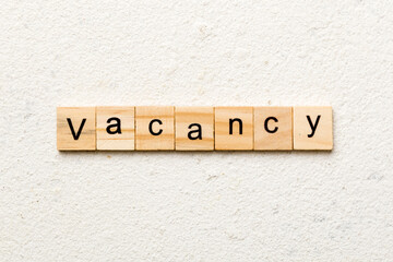 Vacancy word written on wood block. Vacancy text on cement table for your desing, concept