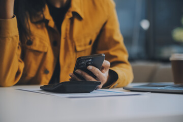 Asian businesswoman in formal suit in office happy and cheerful during using smartphone and working