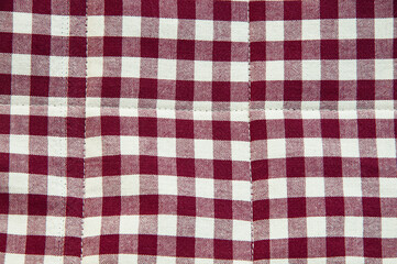 red and white checkered background. material in a dark cell	