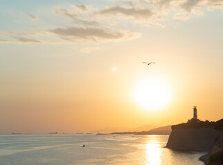 Lighthouse on the island at sunset. Gelendzhik lighthouse on Cape Tolsty of Gelendzhik Bay on the...