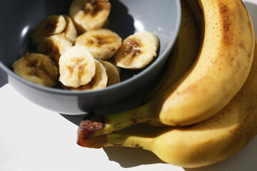 Ripe banana brown skin. Sliced banana background. Bunch of over riped bananas. Food waste background. Food scraps use. Healthy smoothie preparation. Banana salad in bowl.