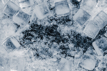 A heap of crushed ice cubes on a black background. - 740147851