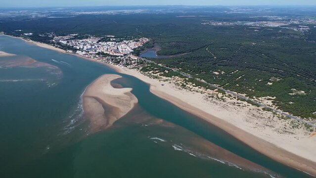 Aerial drone view of the beaches of El Portil,  La Bota, Los Enebrales and Punta Umbria beach, with the natural area Marismas del Odiel in the background, Huelva province, Andalusia, Spain