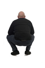 rear view of s squatting man on white background