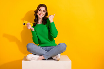 Full body photo of woman green jumper with smartphone follow trends in tiktok point finger empty...