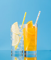 Various lemonade with ice in glasses