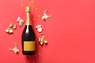 Bottle of champagne with Christmas decorations and confetti on red background