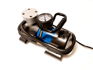 Car air compressor with manometer isolated on a white background