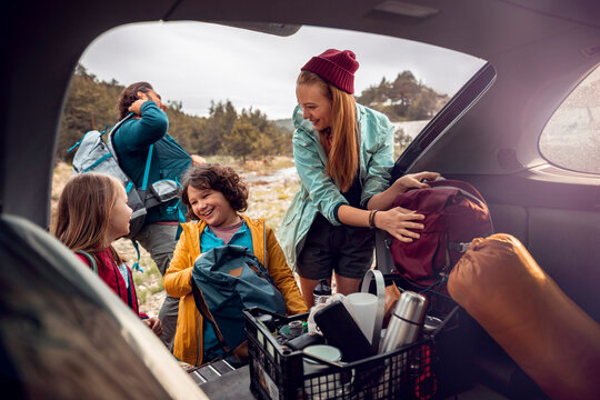 Family packing car for a hiking trip in nature