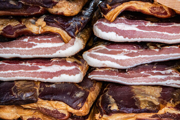 Exposed bacon and dried meat domestic products presented for sale on a farmer's market in Kacarevo village, gastro bacon and dry meat products festival called Slaninijada (bacon festival) held yearly 