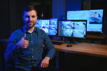 Male security guard in surveillance room
