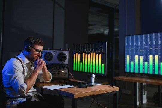 Secret agent listens on the reel tape recorder. Officer wiretapping in headphones