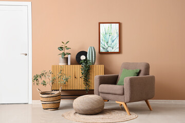 Interior of stylish living room with armchair, pouf and drawers