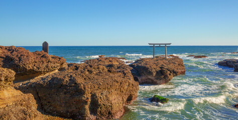 One of the tourist attraction in Japan, Torii gates of Oarai Isosaki-jinja by the sea in bright blue sky day